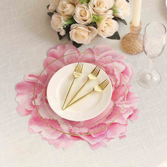 Elegant pink floral table setting with gold utensils and glassware.