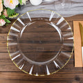 Clear glass plate with gold trim on a wooden table.