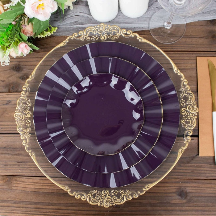 Elegant purple plates with gold accents stacked on a wooden table.